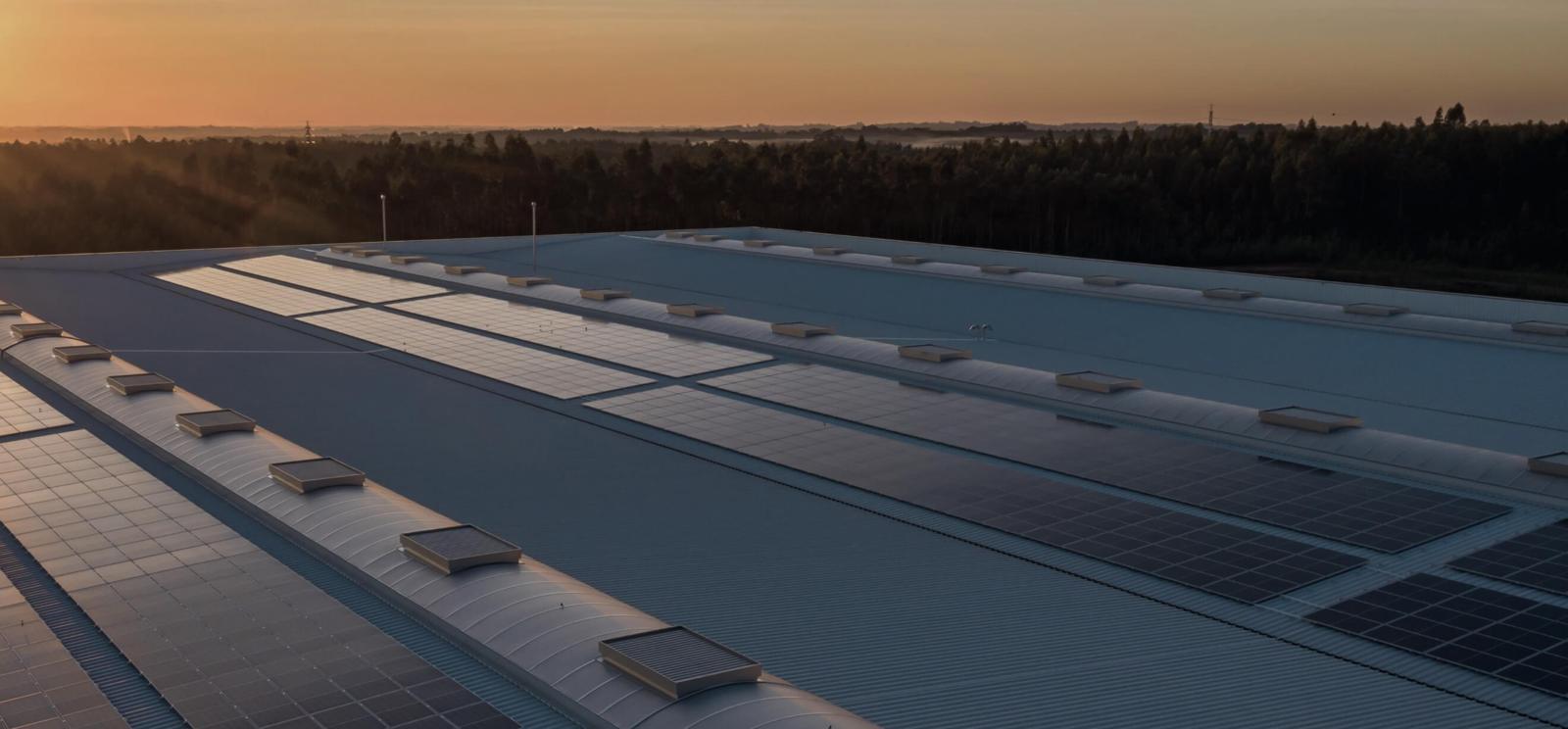Solar panels on a flat rooftop at dusk